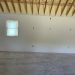 Exposed roof beams inside a building under construction.